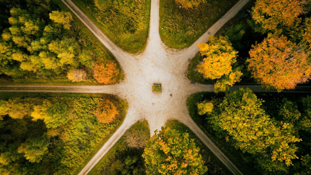 pexels-photo-37327922-37327922 Unique aerial shot of a forest intersection with vibrant autumn foliage in full display.