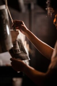 Person developing film in a darkroom, highlighting traditional photography techniques.